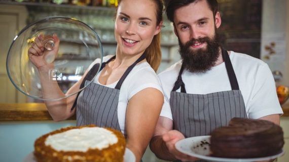 man and woman holding cake