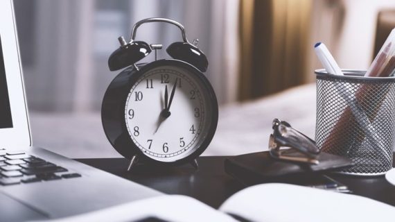 black alarm clock on desk