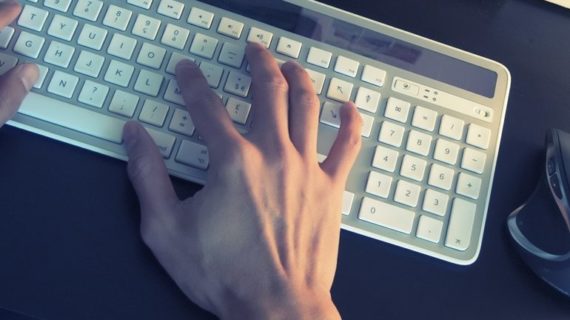 person typing on white keyboard