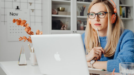 woman using laptop and wearing heaphone