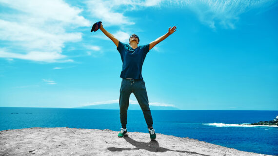 man standing on the cliff of mountain