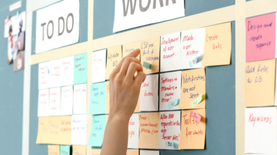 young woman near scrum task board in office