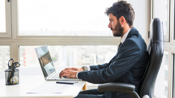 Businessman sitting and working on laptop