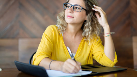 inspired creative woman writing down