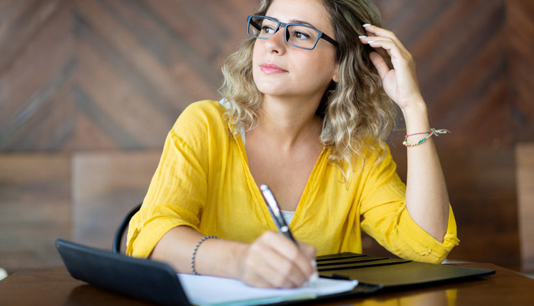 inspired creative woman writing down