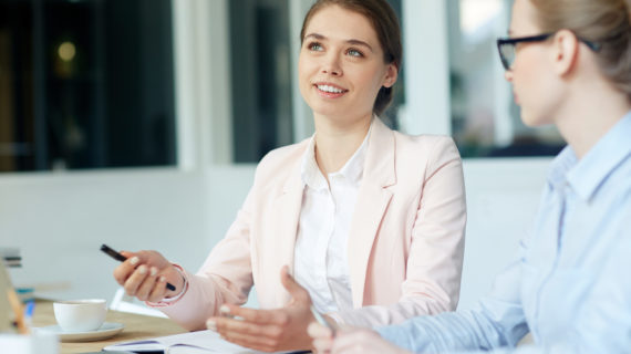 women smiling while discussing