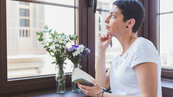 Woman thinking and looking through the window