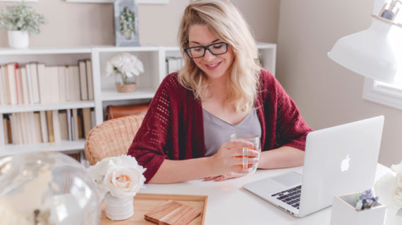 young female working while drinking tea