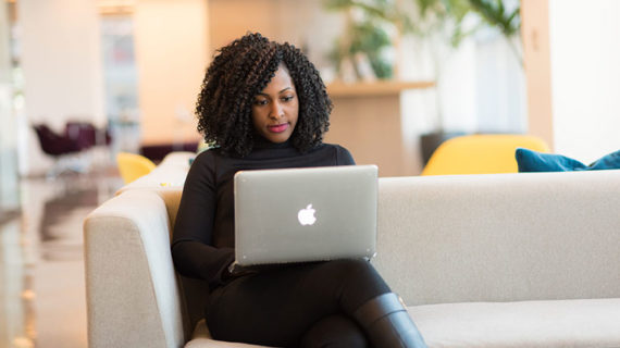 Woman working on the sofa with her laptop