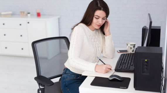 Woman talking on phone and writing