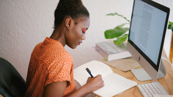 woman writing on her notebook