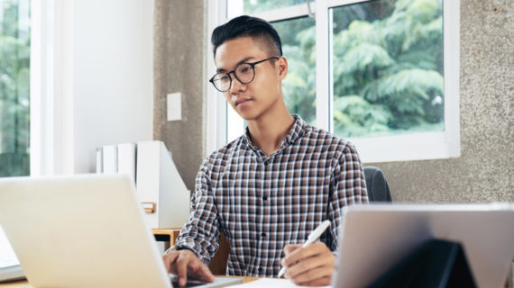 young man working using laptop