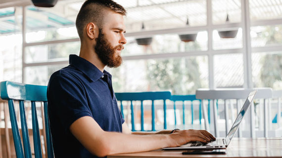 Young man searching for a job online.