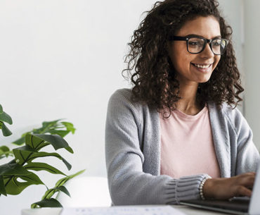 Happy writer working with her laptop