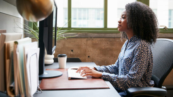 black woman working at a computer