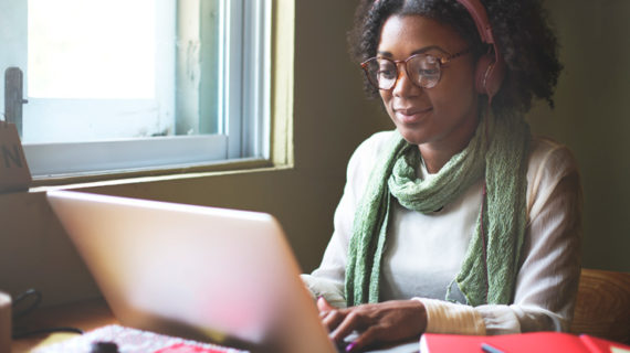 african woman working using her silver laptop