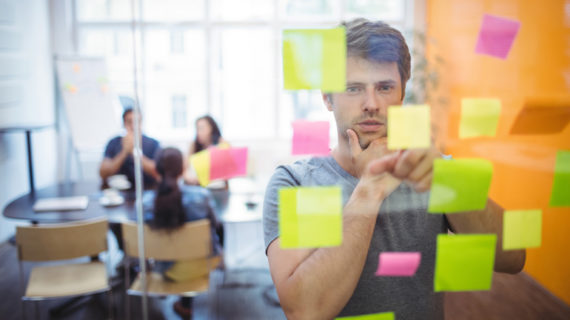 Close-up of male executive reading sticky notes