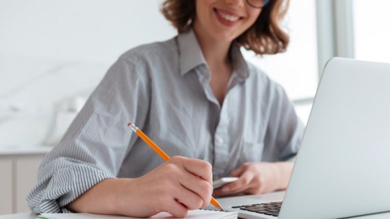 cheerful woman taking down notes