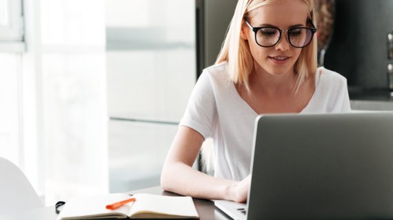 blonde woman working using her laptop