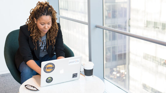 woman working while using her laptop