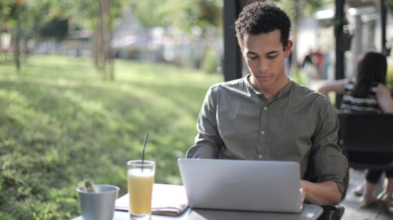 black male freelancer using laptop