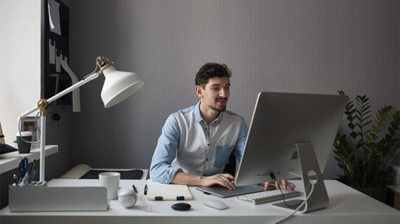 Young man working with his desktop computer