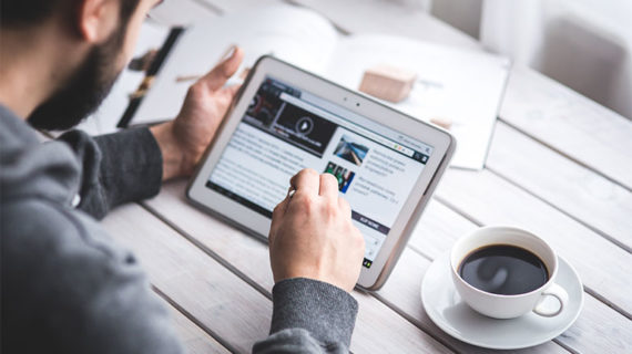 Man reading news on his tablet