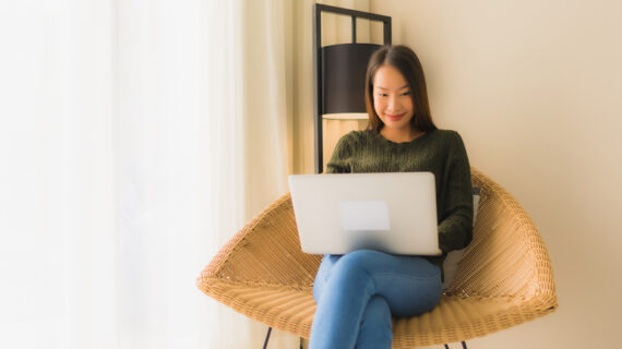 young asian female using laptop