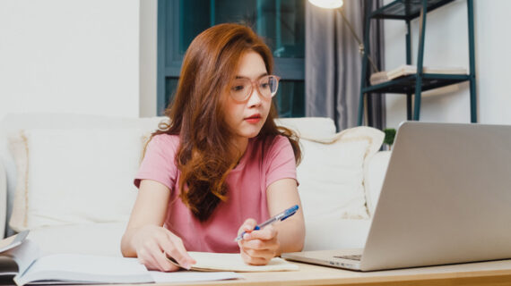 Young asia teen girl working using laptop