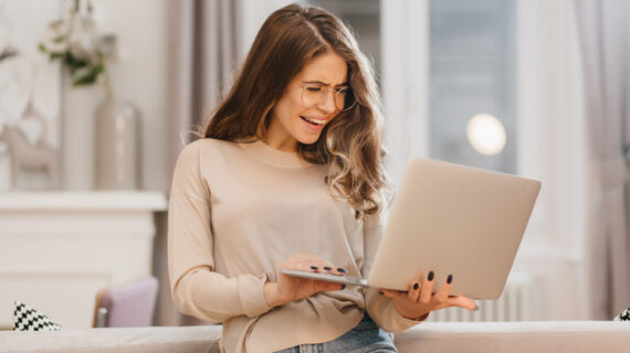 cheerful young woman holding a laptop