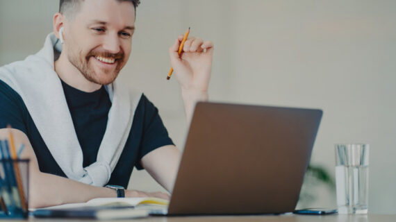 cheerful male working on his laptop