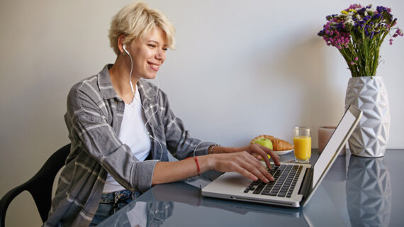 cheerful woman with silver laptop