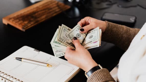 Crop woman counting money