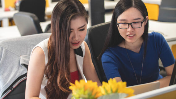 Two woman working online