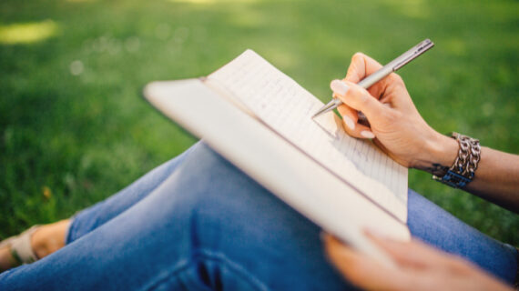 person writing on white paper