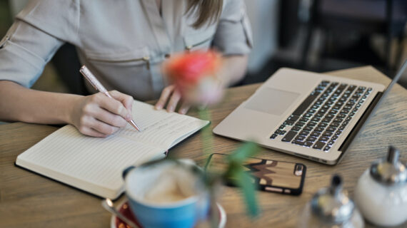 Person writing on a notebook