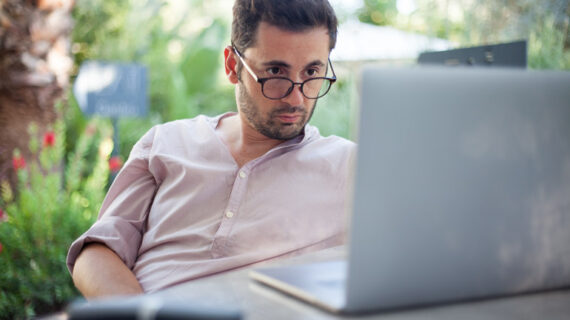 male looking seriously on his laptop