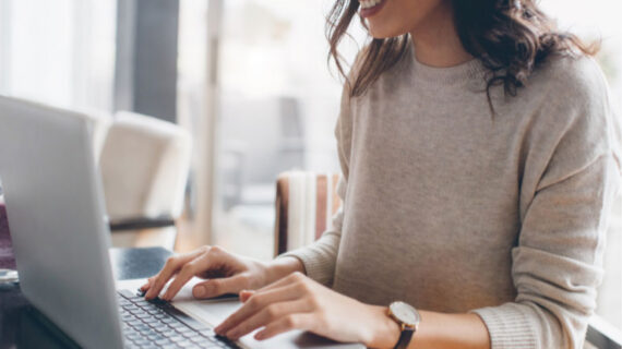 woman typing on a laptop