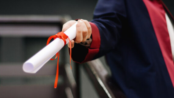 person holding white scroll