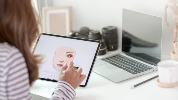 woman using graphic tablet in creative workspace