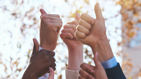 group of people signing thumbs up