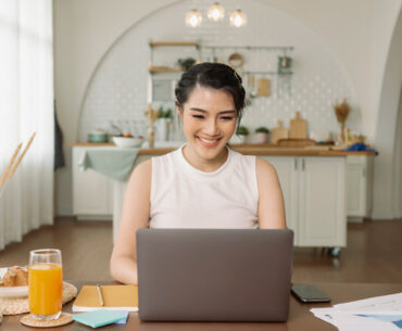 Beautiful young asian woman working on laptop computer