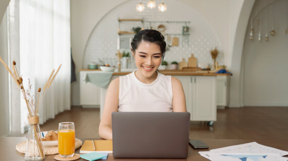 Beautiful young asian woman working on laptop computer