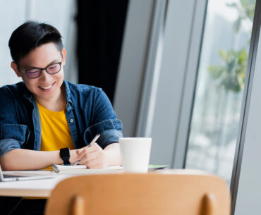 attractive positive asian business male wearing glasses