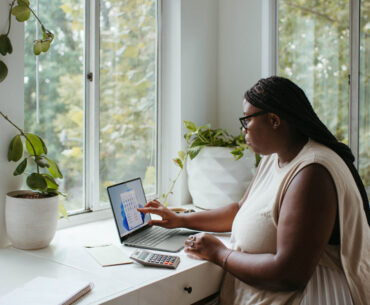 woman sitting at the table while working