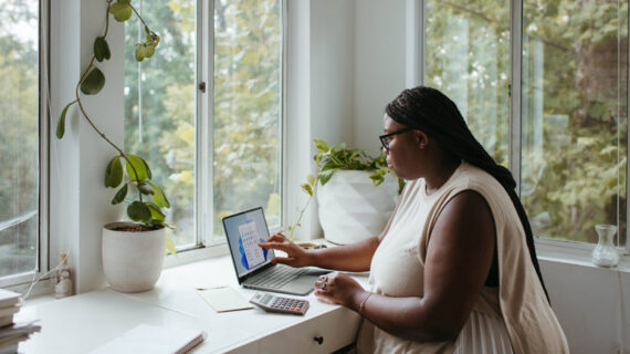 woman sitting at the table while working