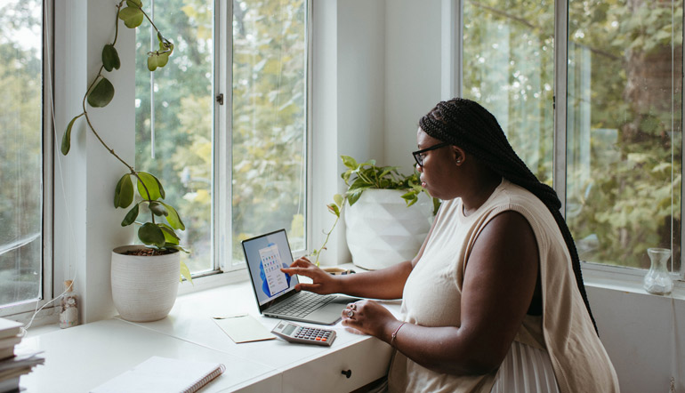 woman sitting at the table while working